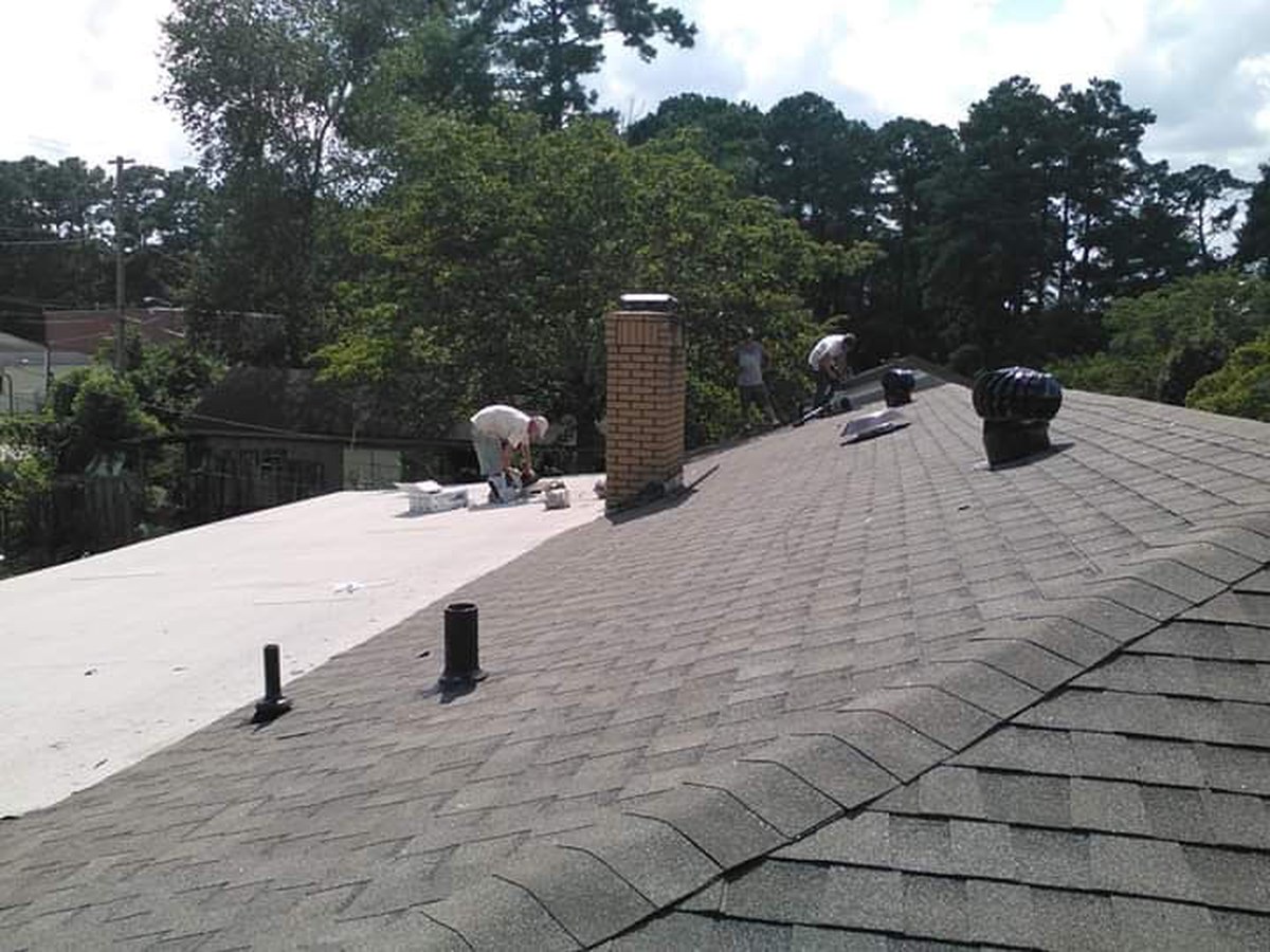 Workers on a shingle roof, from Kenny Roofing's own photos